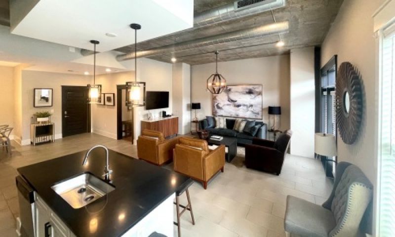 The Village at Commonwealth queen guest suite living room and dining area