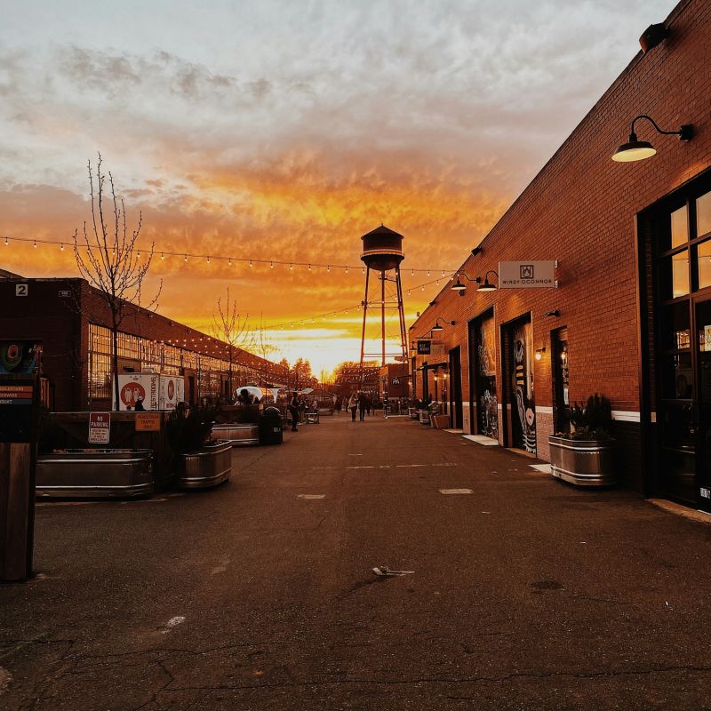 City street at sunset with iconic water tower, Charlotte NC