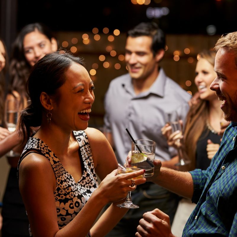 Couples Dancing And Drinking At Evening Party