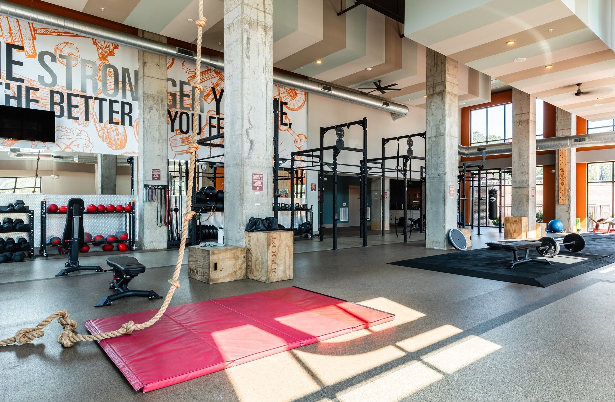 The Village at Commonwealth fitness center with climbing ropes, benches, squat racks, and more