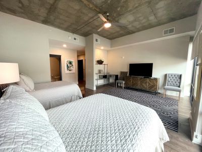 The Village at Commonwealth queen guest suite living room and dining area