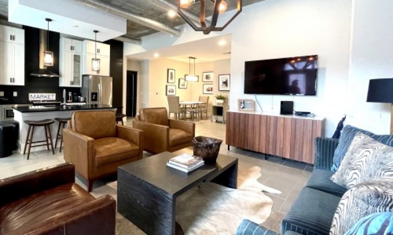 The Village at Commonwealth queen guest suite living room and dining area