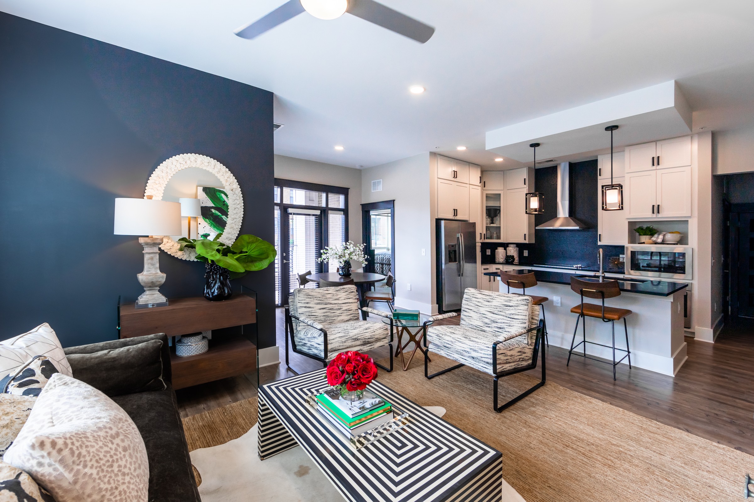 The Village at Commonwealth spacious open floor plan apartment living room and kitchen area with balcony access