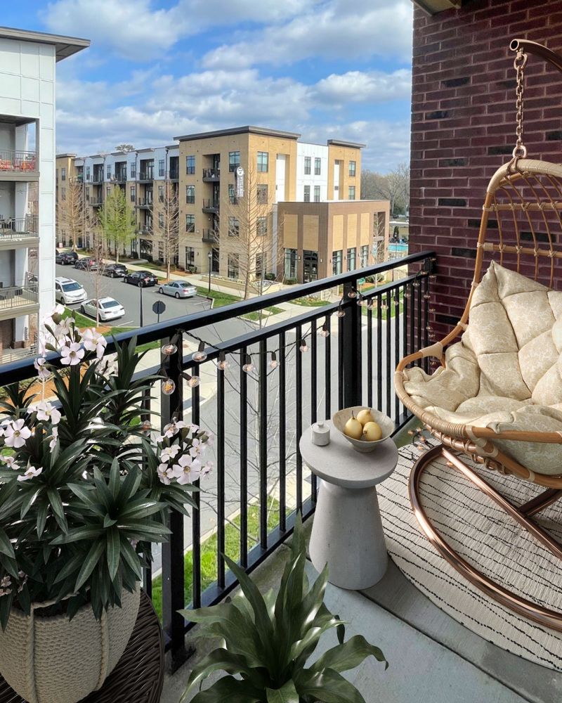 The Village at Commonwealth 3-bedroom large apartment balcony with trendy chair and tropical plants